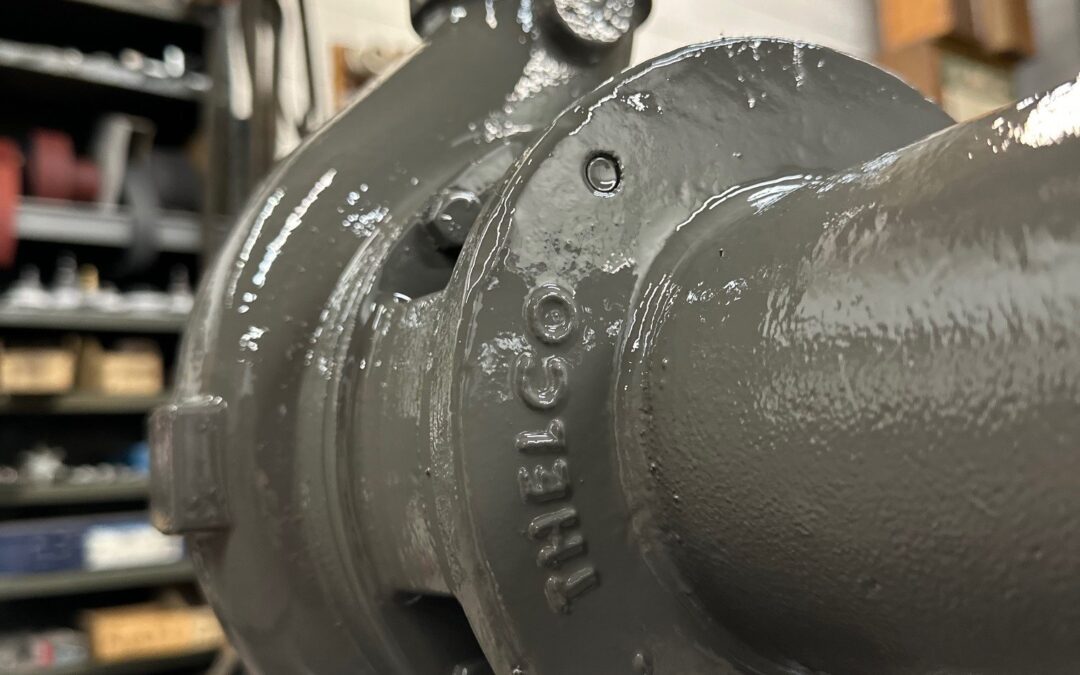 Close-up view of a freshly painted Worthington D814 3x2x5 industrial pump built by Thelco